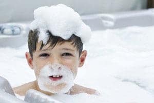 Boy playign with the foam in his Gatlinburg condo with a Jacuzzi tub