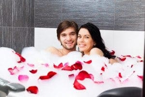 Young couple enjoying a soak in their Gatlinburg condo with a Jacuzzi tub