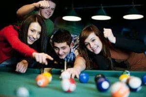 friends playing pool at downtown gatlinburg cabin near the parkway